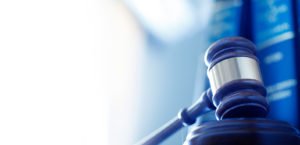 Image of a gavel with law books in the background demonstrating T-Base’s expertise on accessible communications regulations and standards.