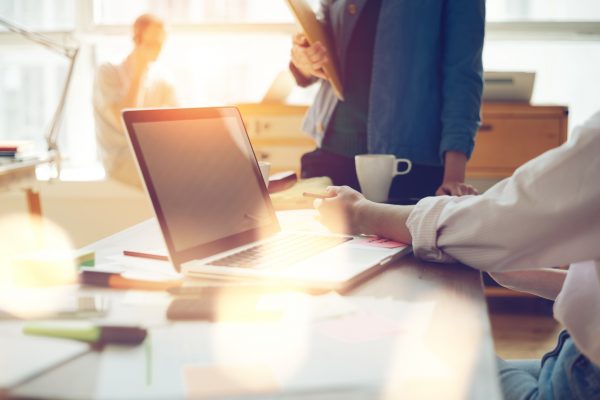 Image of a man in front of a laptop; he's working with accessible digital documents