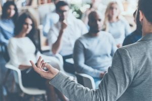 Image of accessibility specialist speaking to a group during a training session
